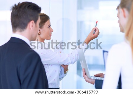 Group of  business people doing presentation with laptop during meeting .