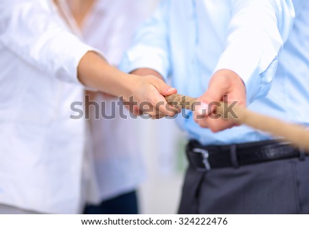 Concept image of business team using a rope as an element  the teamwork on foreground