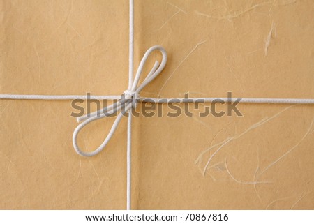 cardboard tag with bow isolated on white background
