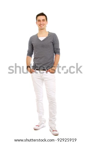 A full-length portrait of a young handsome guy holding hands on pocket, isolated on white background