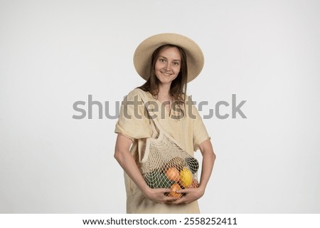 Similar – Image, Stock Photo Cheerful woman with mesh bag full of ripe groceries