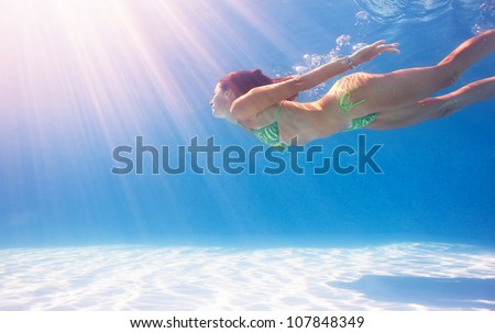 Similar – Image, Stock Photo Young woman in diving mask swimming underwater