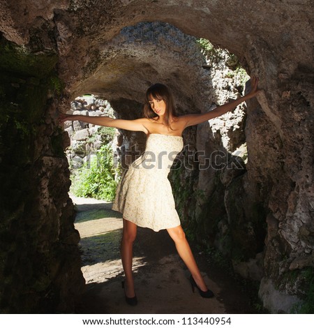 Full body beautiful girl portrait inside a cave.