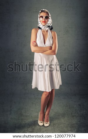 Retro woman wearing sunglasses full body fashion portrait against vintage background.