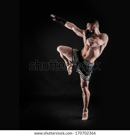 Sportsman kick boxer intense portrait against black background. - stock ...