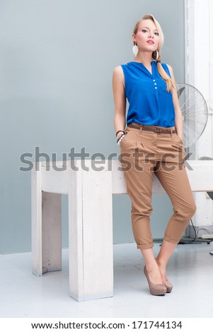 Business woman full body portrait in modern office.
