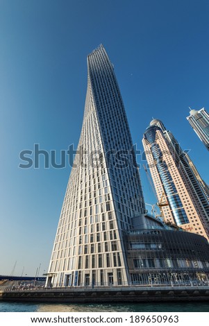 DUBAI, UAE - MARCH 27, 2014: A skyline panoramic view of Dubai Marina and Cayan Tower (known also as Infinity Tower). Dubai Marina is an artificial 3 km canal carved along the Persian Gulf shoreline.