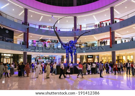 DUBAI, UAE - MARCH 28, 2014: People walking inside Dubai Mall. At over 12 million sq ft, it is the world\'s largest shopping mall.