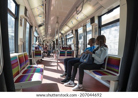 PARIS, FRANCE - MAY 18, 2014: Couple inside Metro wagon. The Paris Metro is a rapid transit system in the Metropolitan Area. It is mostly underground (214 kilometres) and has 303 stations.