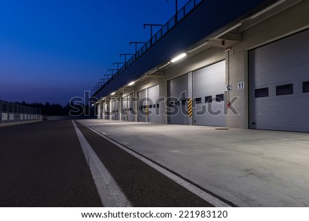 Garages in race circuit. Night time.