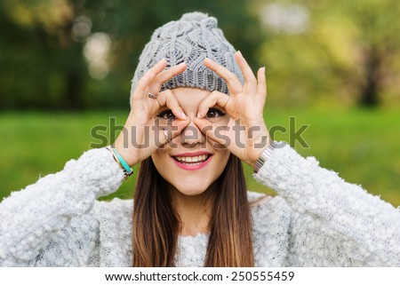 Close up portrait of young woman with fake glasses in a park.