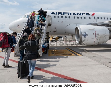 BOLOGNA, ITALY - APRIL 5, 2015: Boarding Air France Jet airplane at Bologna airport. The airport is named after Bologna native G. Marconi, an Italian electrical engineer and Nobel laureate.