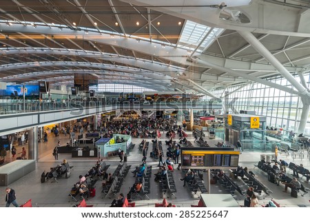 LONDON - MAY 21, 2015: People walking inside terminal of Heathrow Airport, the busiest airport in the United Kingdom and the busiest airport in Europe by passenger traffic.