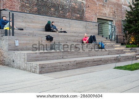 NEW YORK CITY - MAY 2015: People relaxing on the High Line Park. The High Line is a park built on an historic freight rail line elevated above the streets in the West Side.