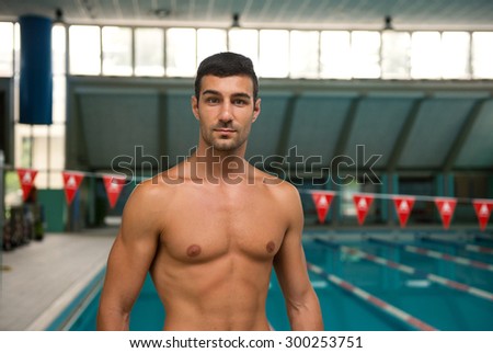 Portrait of professional man swimmer inside swimming pool.