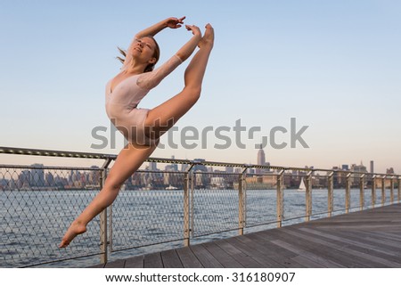 Young beautiful ballerina dancing along New Jersey waterfront with New York skyline in the background. Ballerina Project.