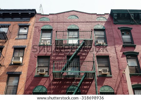 NEW YORK CITY - MAY 13, 2015: Facade of an old red brick apartment building in Little Italy, New York.