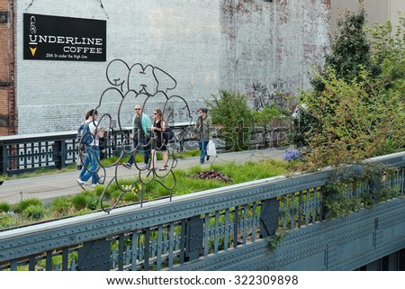 NEW YORK CITY - MAY 6, 2015: People walking on the High Line Park. The High Line is a park built on an historic freight rail line elevated above the streets in the West Side.