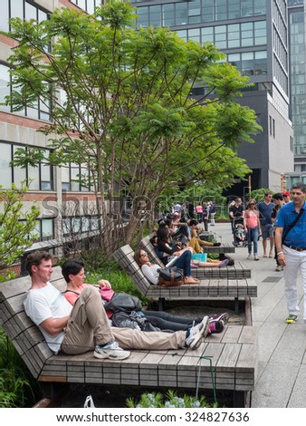 NEW YORK CITY - MAY 16, 2015: People walking on the High Line Park. The High Line is a park built on an historic freight rail line elevated above the streets in the West Side.