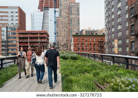 NEW YORK CITY - MAY 16, 2015: People relaxing on the High Line Park. The High Line is a park built on an historic freight rail line elevated above the streets in the West Side.
