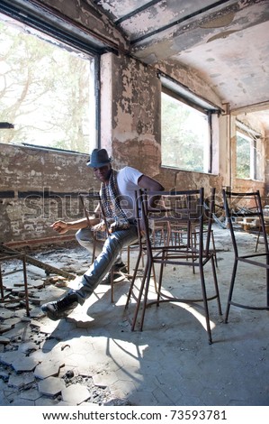 Black man intense portrait inside abandoned building.