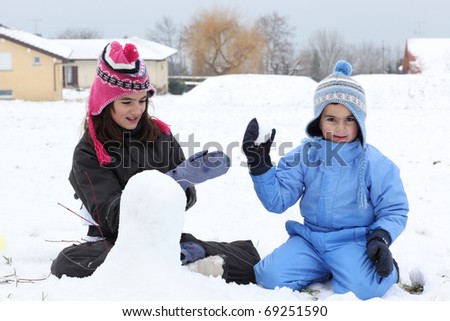 children playing in the snow outside and having fun