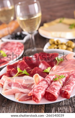 plate with meats and wine glass