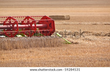 combine harvester blades closeup - cutting the wheat