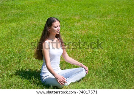 Girl sitting doing yoga outdoor
