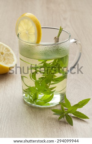Glass with lemon verbena tea and lemon