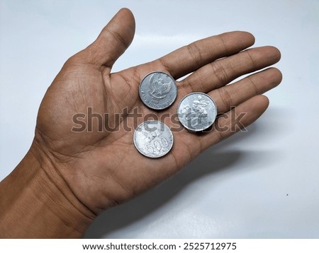 Similar – Image, Stock Photo hand holding 500 coins indonesian rupiah