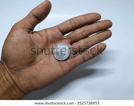 Image, Stock Photo hand holding 500 coins indonesian rupiah