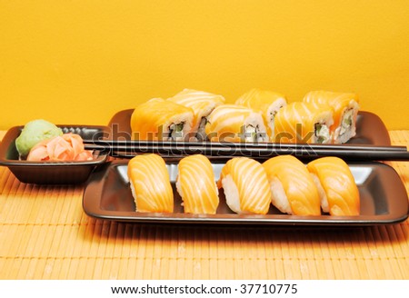 Sushi in metal plates on bamboo mat