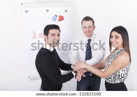 group of business people with hands on top of each other. Studio shot on a white Background.