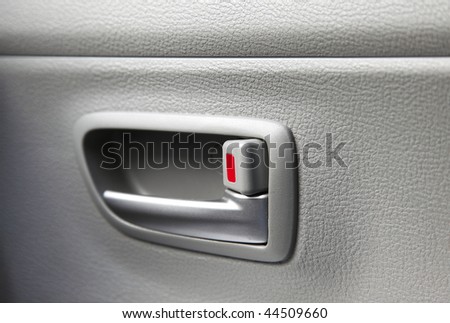 car door with a red child safety lock