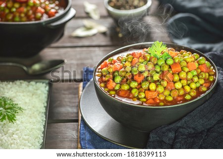 Arabic Cuisine; Middle Eastern traditional peas and carrot stew. A delicious vegan meal with peas and carrot doused in aromatic tomato sauce. Served with white rice and oriental pickles. Сток-фото © 