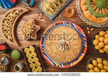 Arabic Cuisine: Middle Eastern desserts. Delicious collection of Ramadan traditional desserts. Served with tasty nuts, honey syrup and sugar syrup .Top view with close up.