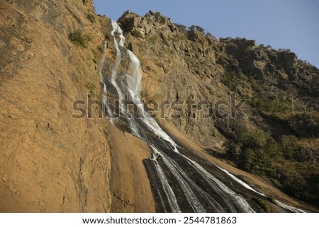 Similar – Image, Stock Photo Waterfall flowing through autumn forest in daylight