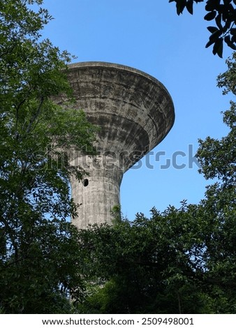 Similar – Image, Stock Photo Vintage water tank on high rusty iron frame in front of grey clouds