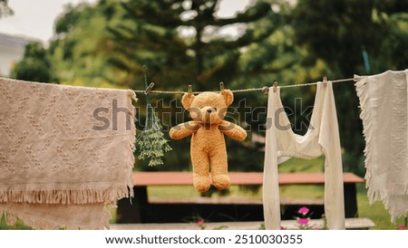 Similar – Image, Stock Photo Towels on clothesline between two trees on the campsite. In the background a caravan with awning.