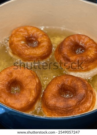 Similar – Image, Stock Photo Cooking doughnuts process. Homemade dough and deep-fried donuts, top view