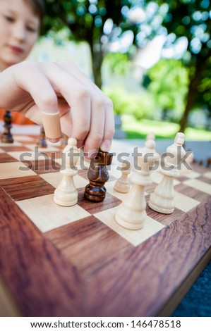 Close up of male hand moves piece in chess, taken with wide angle objective