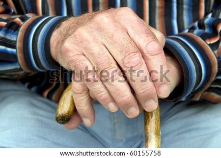 hand of a senior man holding a cane