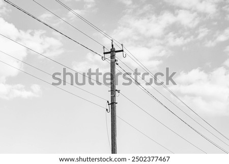 Image, Stock Photo An old wooden power pole and power lines, bushes and sky