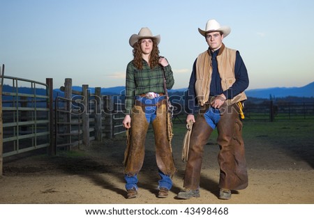 Cowgirl and cowboy couple against a sunset sky