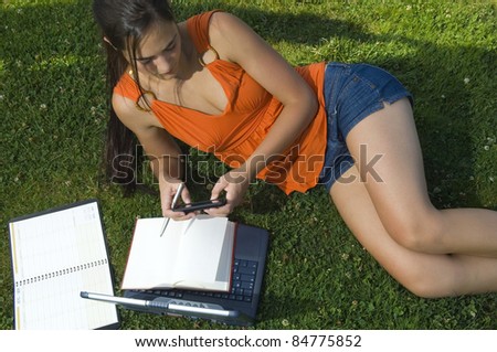 College Student studying in park with Laptop