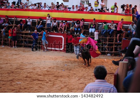 SAN JUAN, HUELVA, SPAIN - JUNE 23: The festival of St. John the Baptist\'s. Running of the Bulls of San Juan is the most popular celebration in Andalusia on June 23, 2013 in San Juan, Huelva, Spain