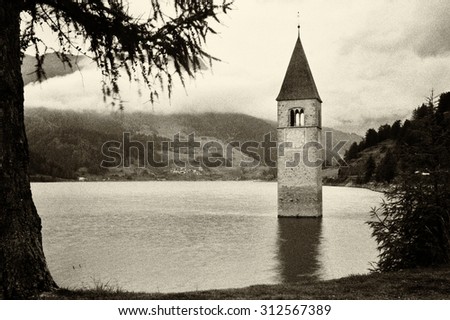 Resia, Italy: famous old bell tower on the lake - high noise added
