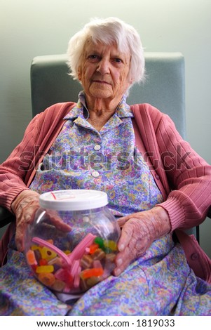 Old woman portrait, 93 years old, holding jar of lollies