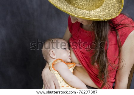 Mother breast feeding her six months old baby girl